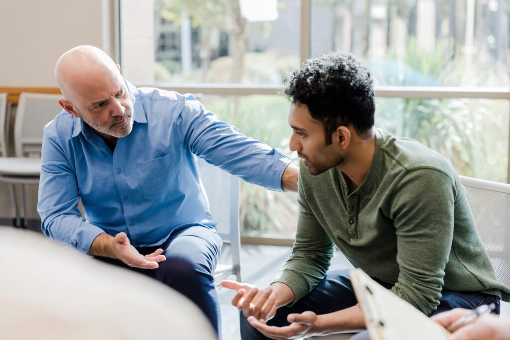 male clinician working with young male client during mental health treatment in Bedford