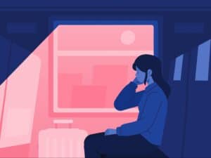 A person deep in thought, staring out a train window contemplating the challenges they are going through in addiction recovery.