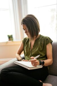 A patient practicing a healthy coping strategy of journeling to reduce stress. 