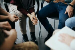 A outpatient group therapy session takes place in this image. 