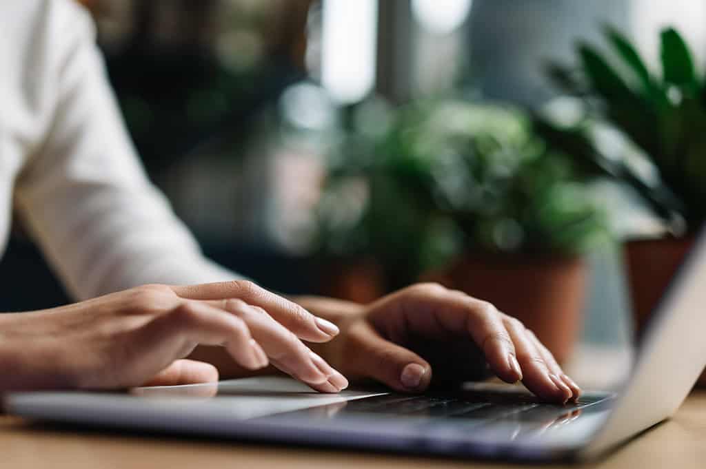 Woman working on a laptop during inpatient rehab
