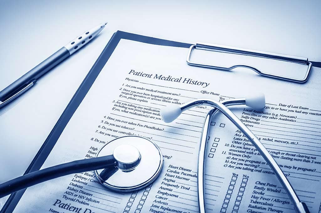 medical record charts with stethoscope Does Rehab Show Up on Your Medical Records?