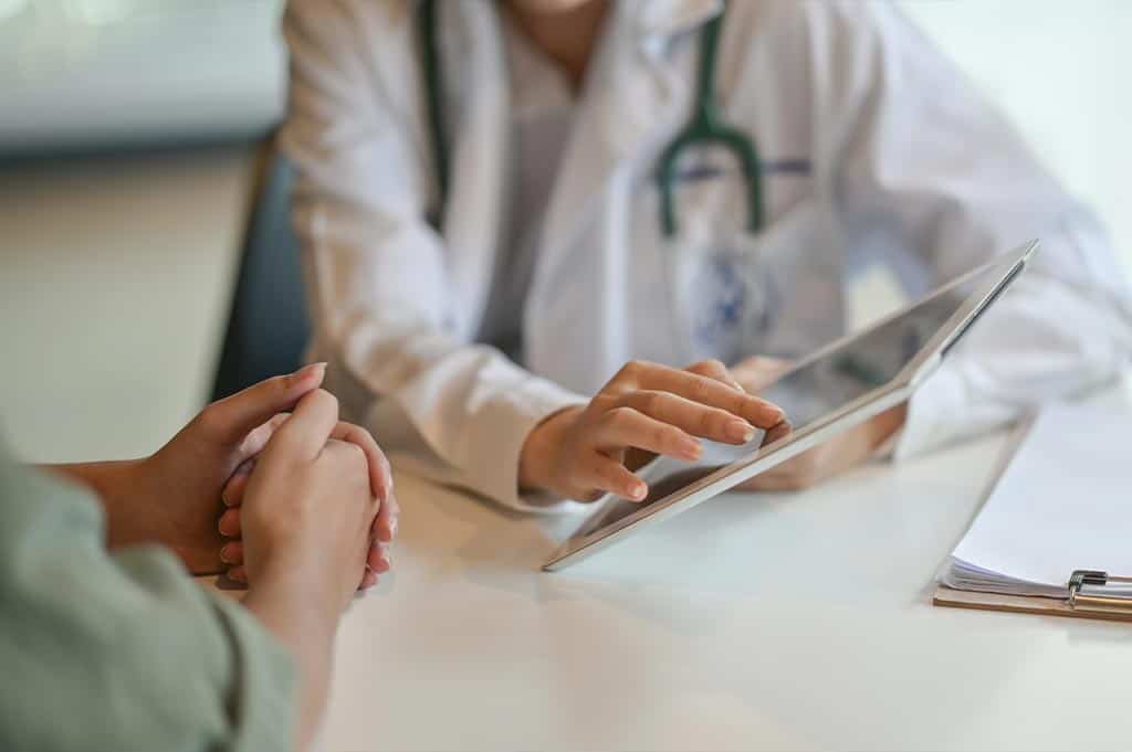patient sitting with doctor during a consultation while reviewing the possible suboxone side effects
