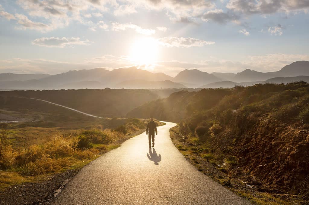 Person walking along a path symbolizing relapse prevention and long-term addiction recovery