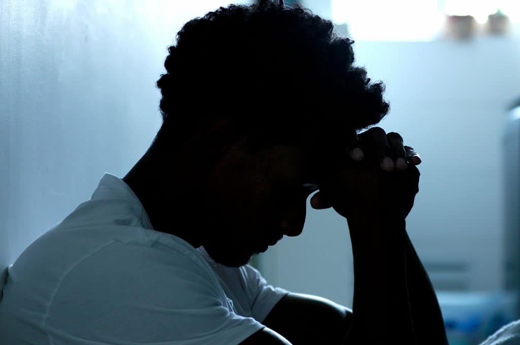 Man holding his head dealing with alcohol withdrawal