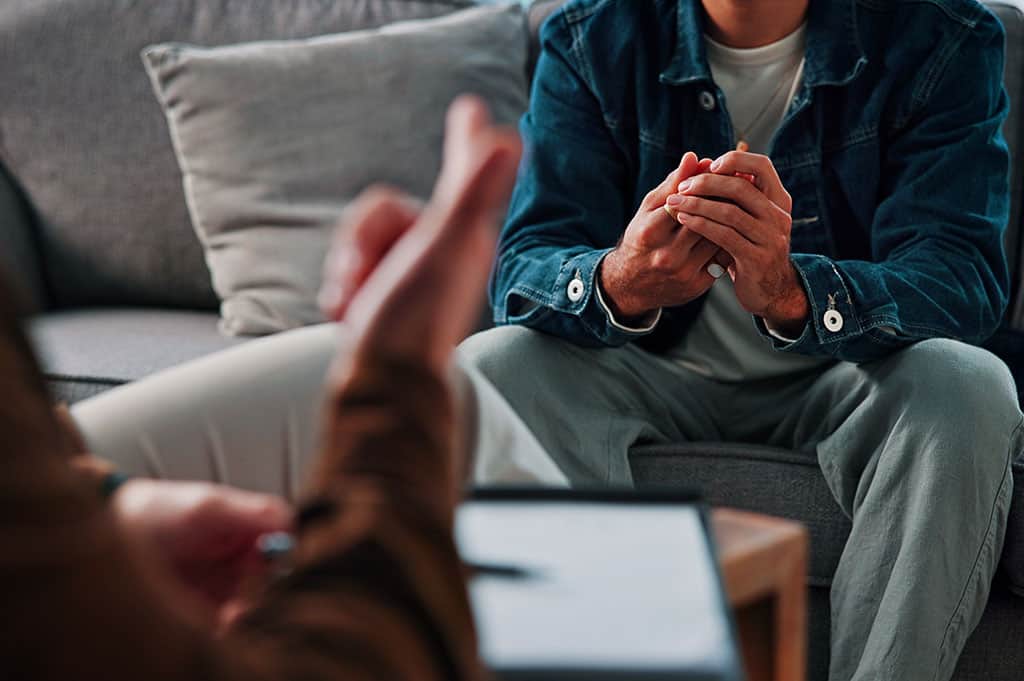 Man talking with a counselor about medication-assisted treatment options